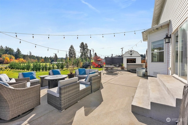 view of patio with a hot tub and outdoor lounge area