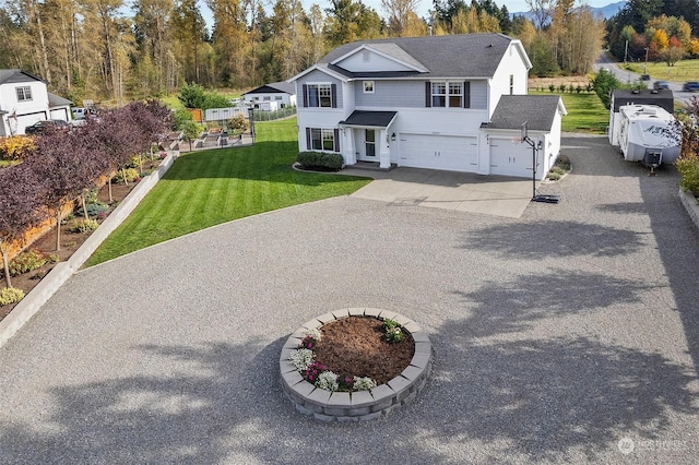 view of front of property featuring a garage and a front lawn