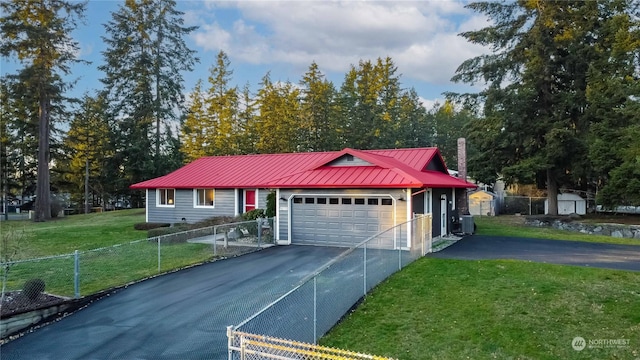 view of front of home with a garage, cooling unit, and a front lawn