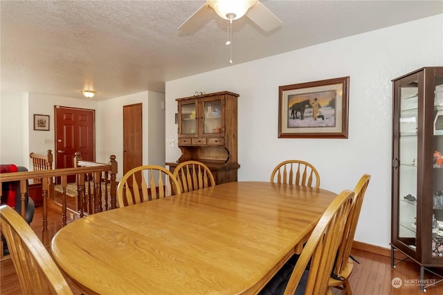 dining space featuring ceiling fan, light hardwood / wood-style floors, and a textured ceiling