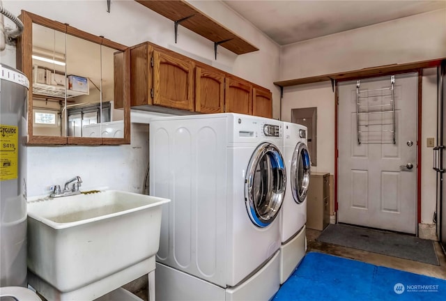 clothes washing area featuring sink, cabinets, and washer and dryer