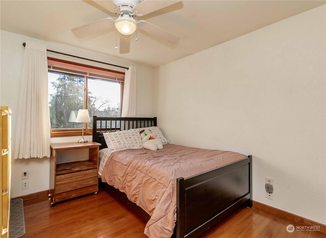 bedroom with hardwood / wood-style flooring and ceiling fan