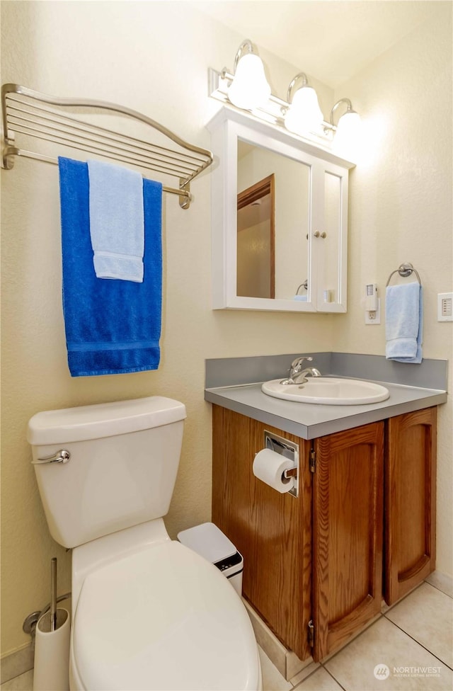 bathroom with vanity, tile patterned floors, and toilet