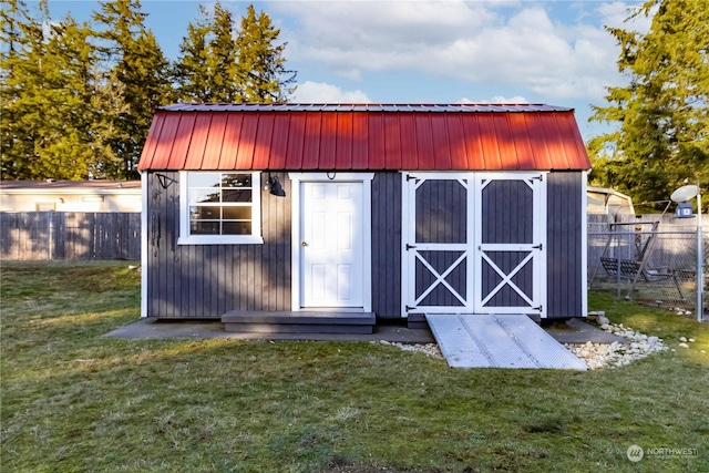 view of outbuilding featuring a lawn