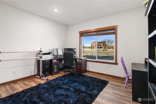 home office with hardwood / wood-style flooring