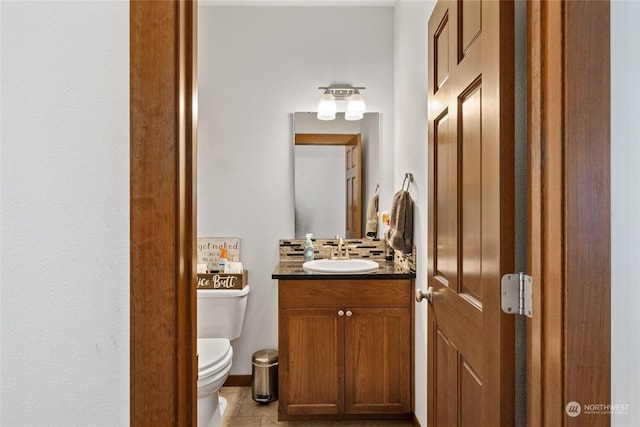 bathroom featuring vanity, toilet, and tile patterned flooring