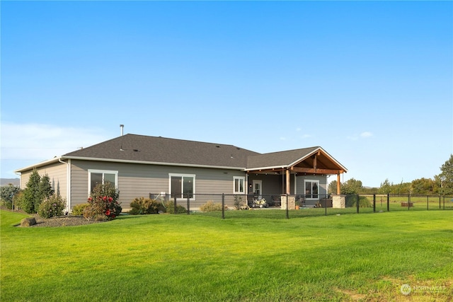 rear view of property with a yard