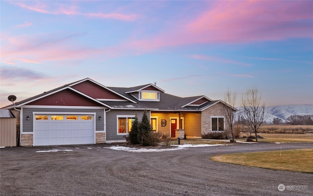 craftsman house with a garage and a mountain view