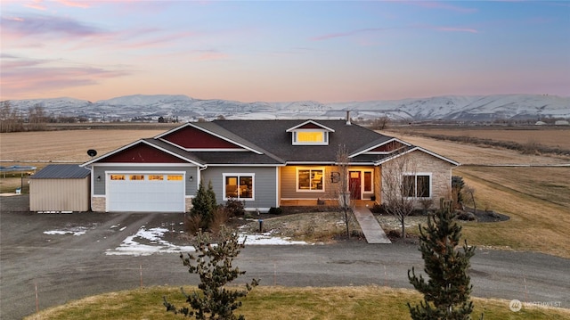 view of front of property with a garage and a mountain view