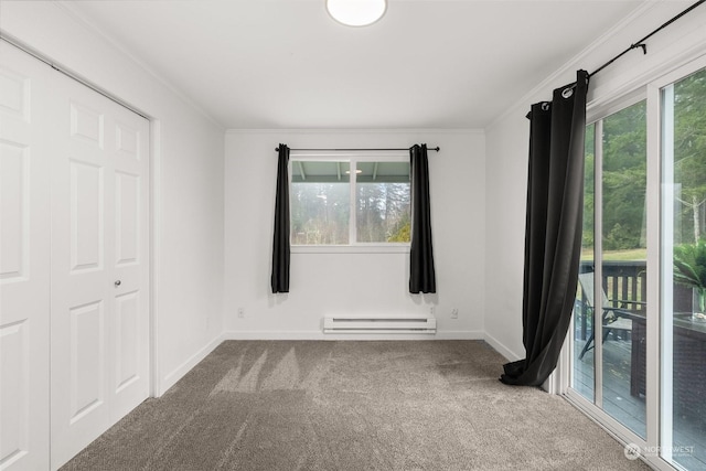 unfurnished bedroom with crown molding, carpet floors, multiple windows, and a baseboard heating unit