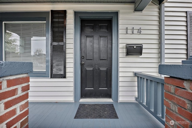 doorway to property featuring a porch