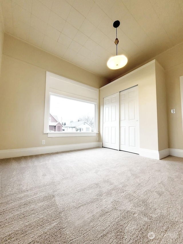 unfurnished bedroom with a closet and carpet