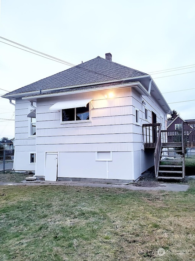 view of side of home with a yard