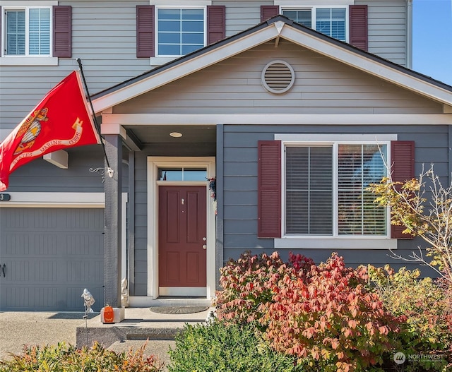 view of exterior entry with a garage