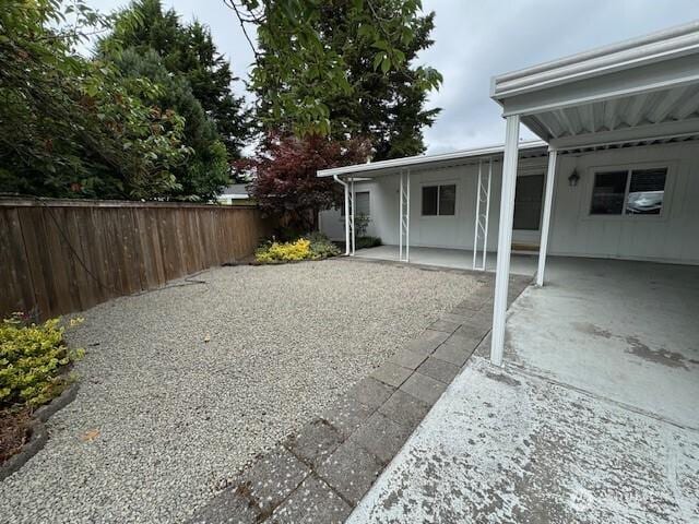 375 Union Ave SE Unit 125, Renton, WA 98059 - view of yard featuring a carport, a patio area, and gravel driveway