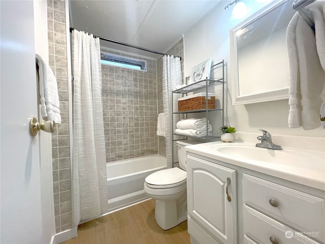 full bathroom with wood-type flooring, toilet, shower / tub combo, and vanity