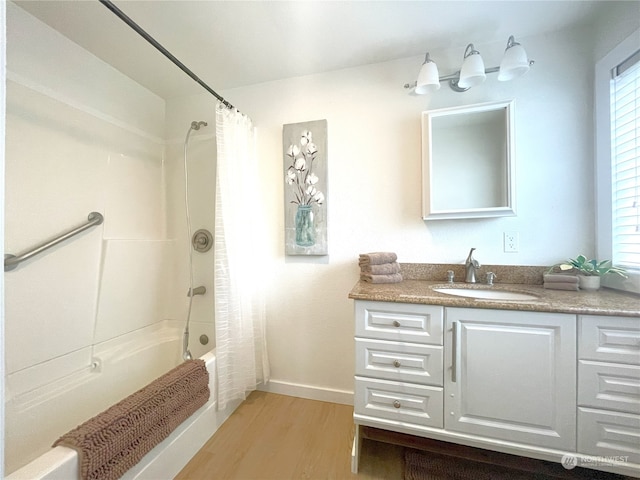 bathroom with shower / bathtub combination with curtain, hardwood / wood-style floors, and vanity