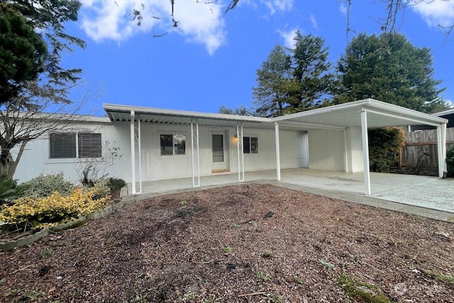 back of house with a carport