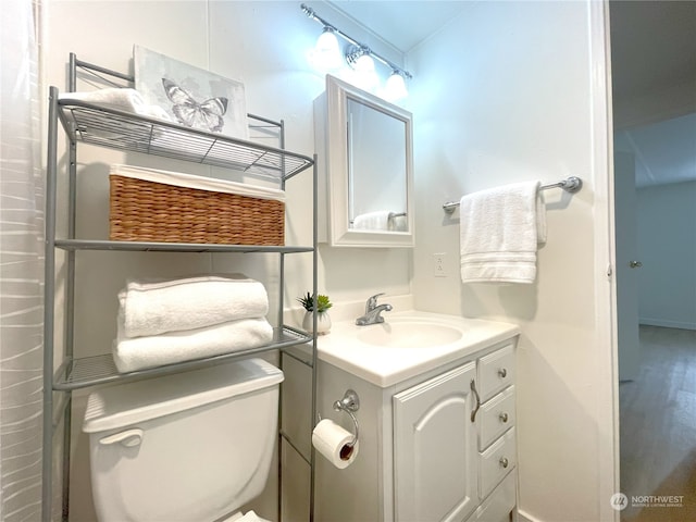 bathroom featuring vanity and toilet