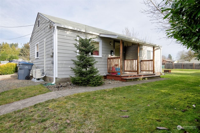 view of front of property with ac unit and a front yard