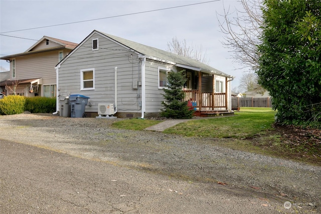 view of property exterior featuring a lawn and ac unit