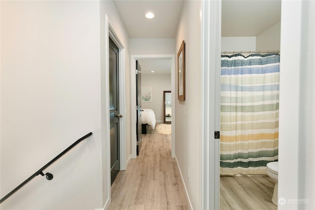 corridor with light hardwood / wood-style flooring