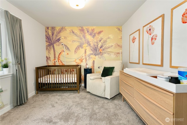 carpeted bedroom featuring a nursery area