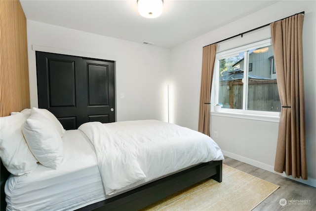 bedroom with hardwood / wood-style flooring