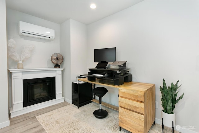 office space featuring a wall unit AC and light hardwood / wood-style flooring