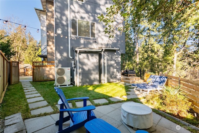 back of property with ac unit, a patio, and a lawn