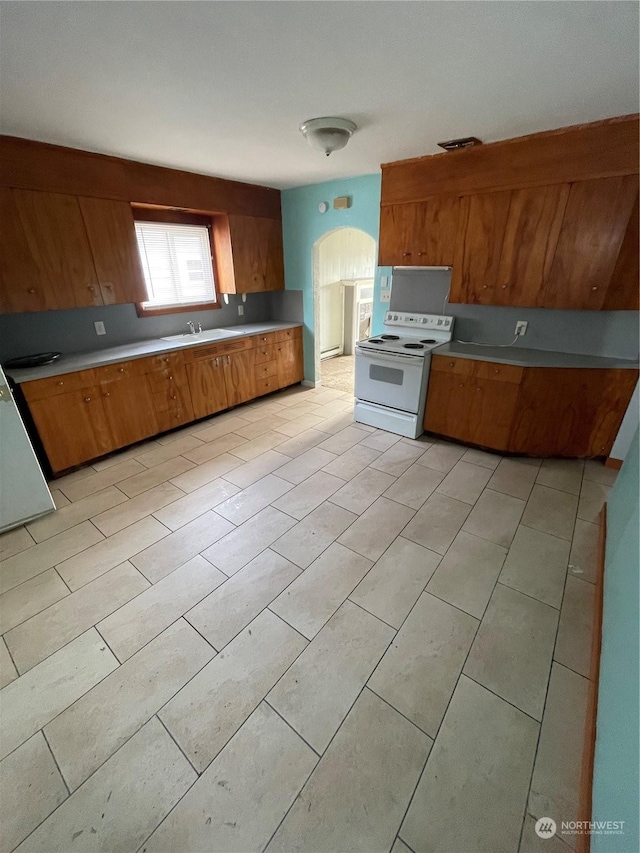 kitchen featuring sink, white electric range, and light tile patterned floors