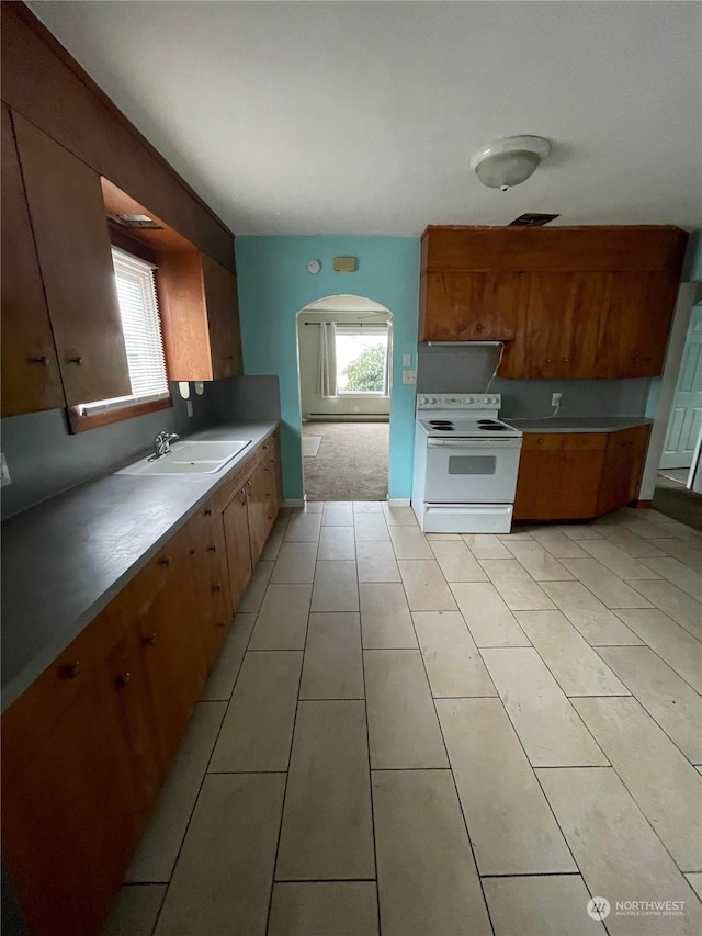 kitchen with sink, white electric range oven, and light tile patterned floors