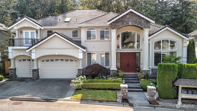 view of front of house featuring a garage and a balcony