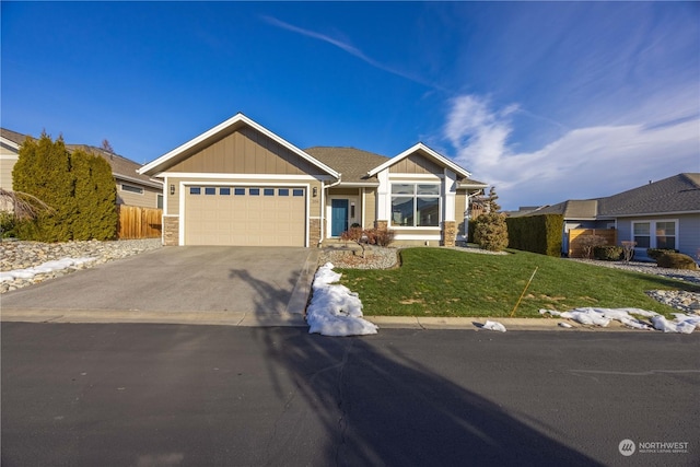 single story home featuring board and batten siding, a front lawn, fence, a garage, and driveway