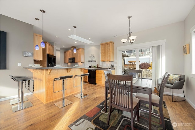 dining room with an inviting chandelier and light hardwood / wood-style floors