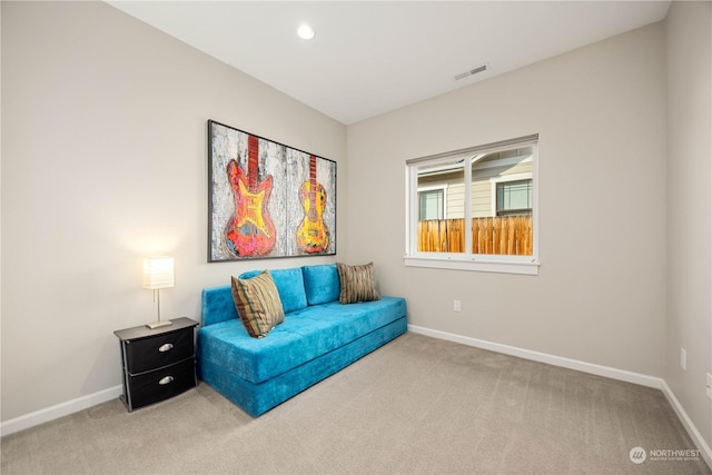 living area with carpet floors, recessed lighting, visible vents, and baseboards