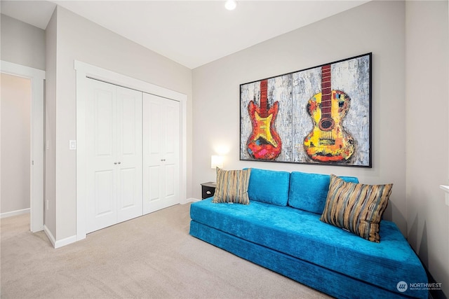 sitting room featuring carpet floors and baseboards