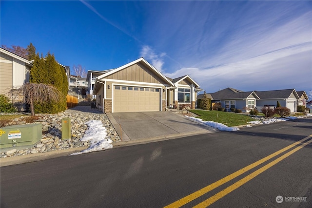 view of front of property with an attached garage, a residential view, board and batten siding, and concrete driveway