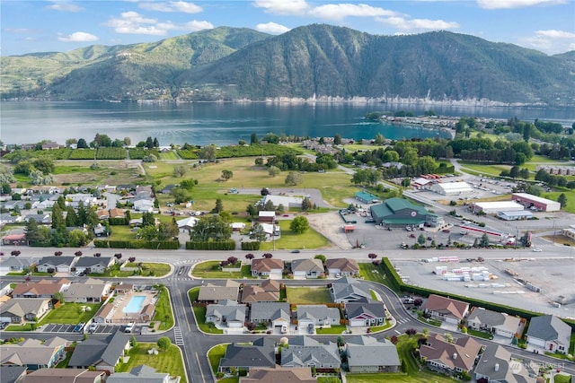 birds eye view of property featuring a water and mountain view