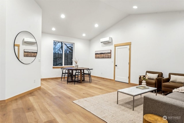 living room with high vaulted ceiling, a wall mounted AC, and light hardwood / wood-style floors