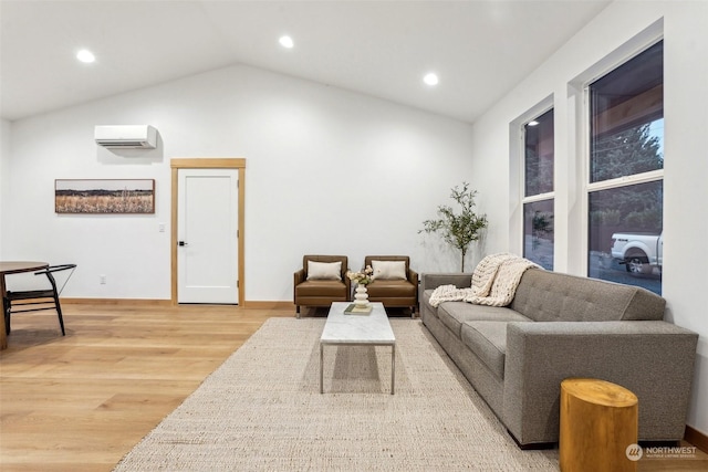 living room featuring lofted ceiling, a wall mounted AC, and hardwood / wood-style floors