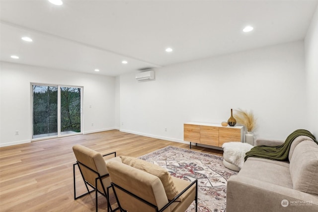 living room featuring hardwood / wood-style floors and an AC wall unit