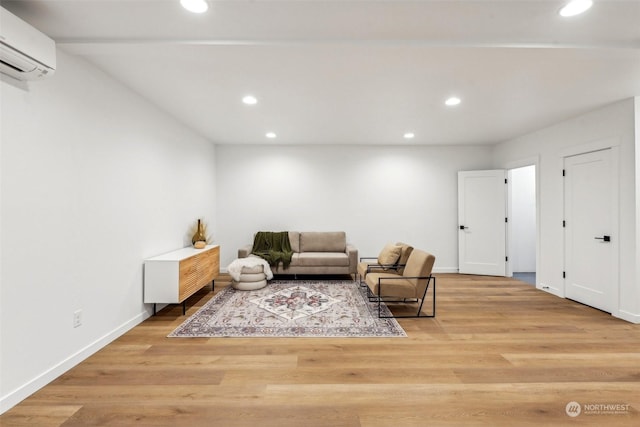 living room with light hardwood / wood-style flooring and an AC wall unit