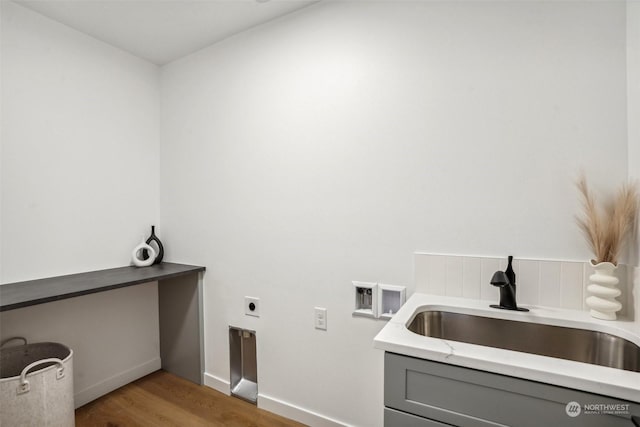 laundry room with electric dryer hookup, sink, washer hookup, and light wood-type flooring