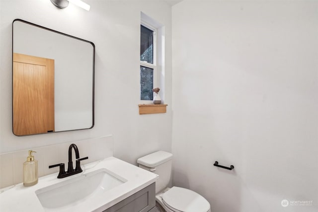 bathroom featuring vanity and toilet