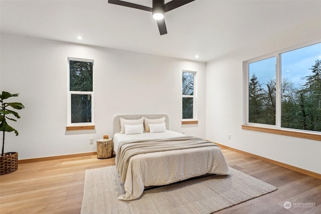 bedroom with ceiling fan and light hardwood / wood-style flooring