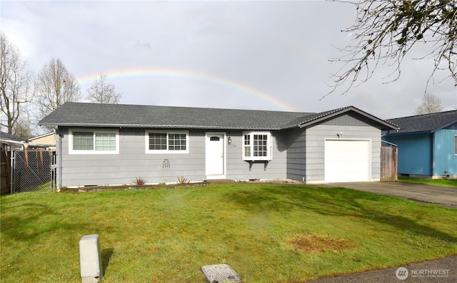 ranch-style home with a garage, fence, and a front lawn