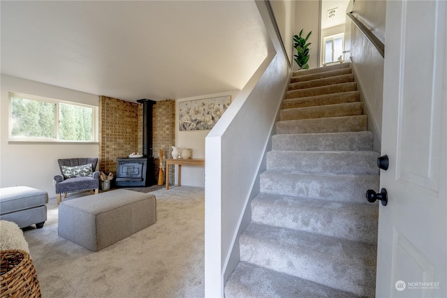 staircase with carpet and a wood stove