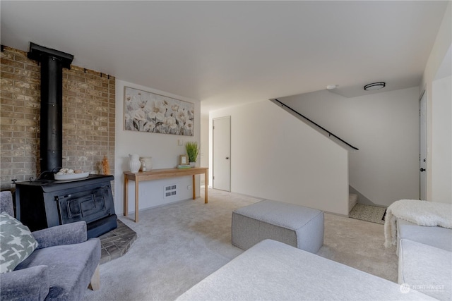 living room with light carpet and a wood stove