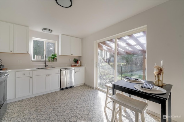 kitchen featuring white cabinetry, sink, dishwasher, and range